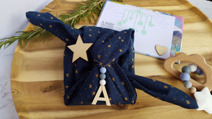 Fabric gift wrapping service. Includes card, wrapping, unique finishing touches.